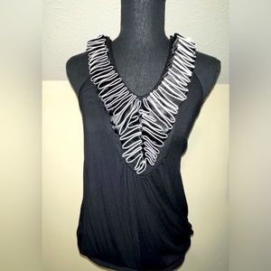 Black blouse, white and black cap sleeves with ruffled V bouchée front